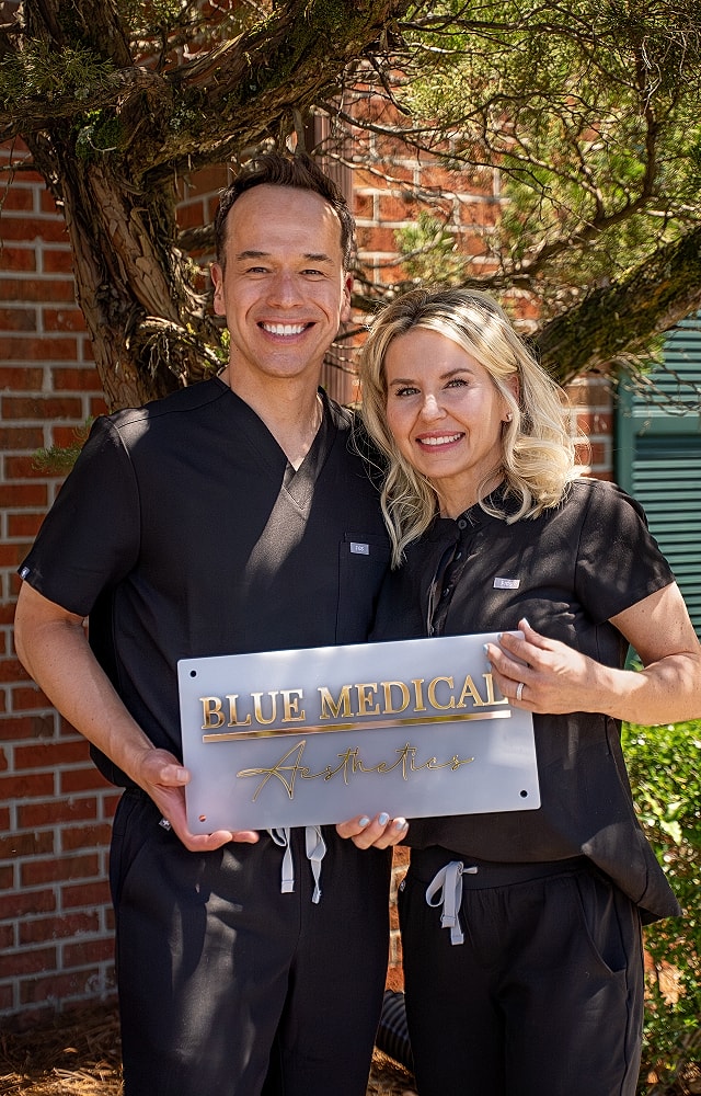 Medical professionals holding a sign outside.