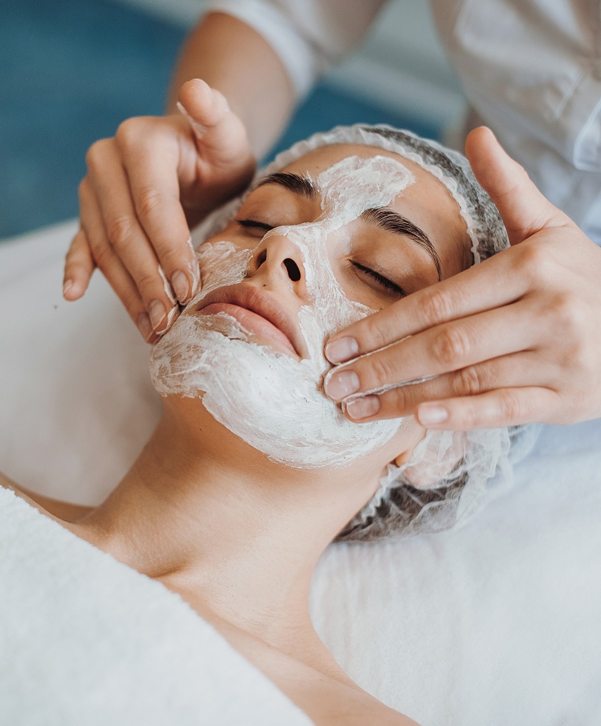Woman receiving a facial treatment in spa.
