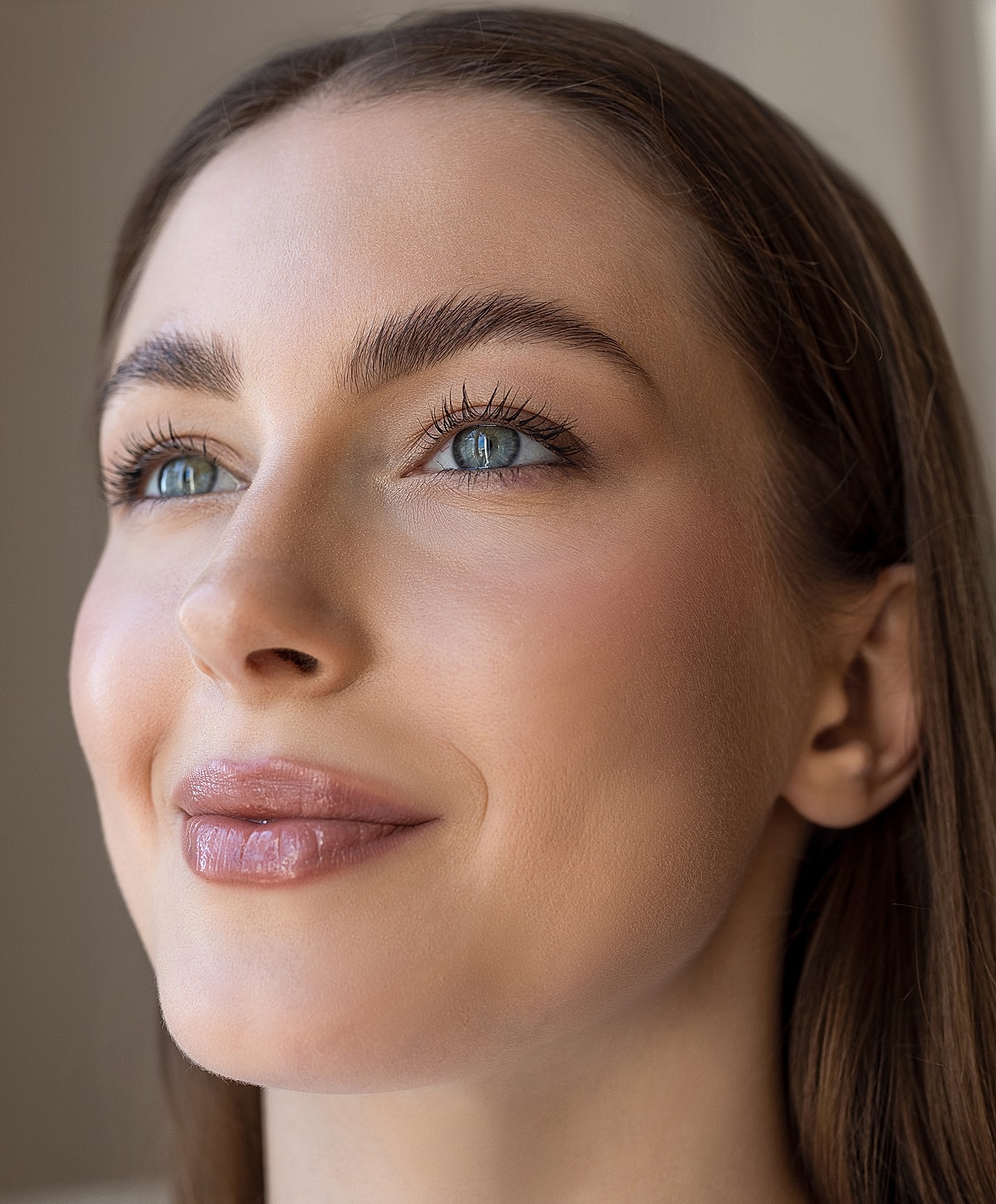 Close-up of a smiling woman with soft makeup.