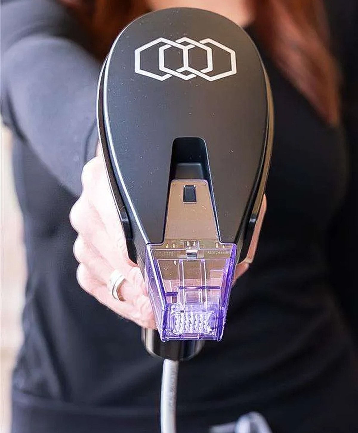 Handheld tool with purple light feature.