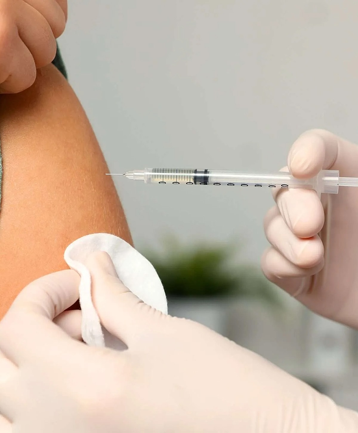 Administering a vaccine with a syringe.
