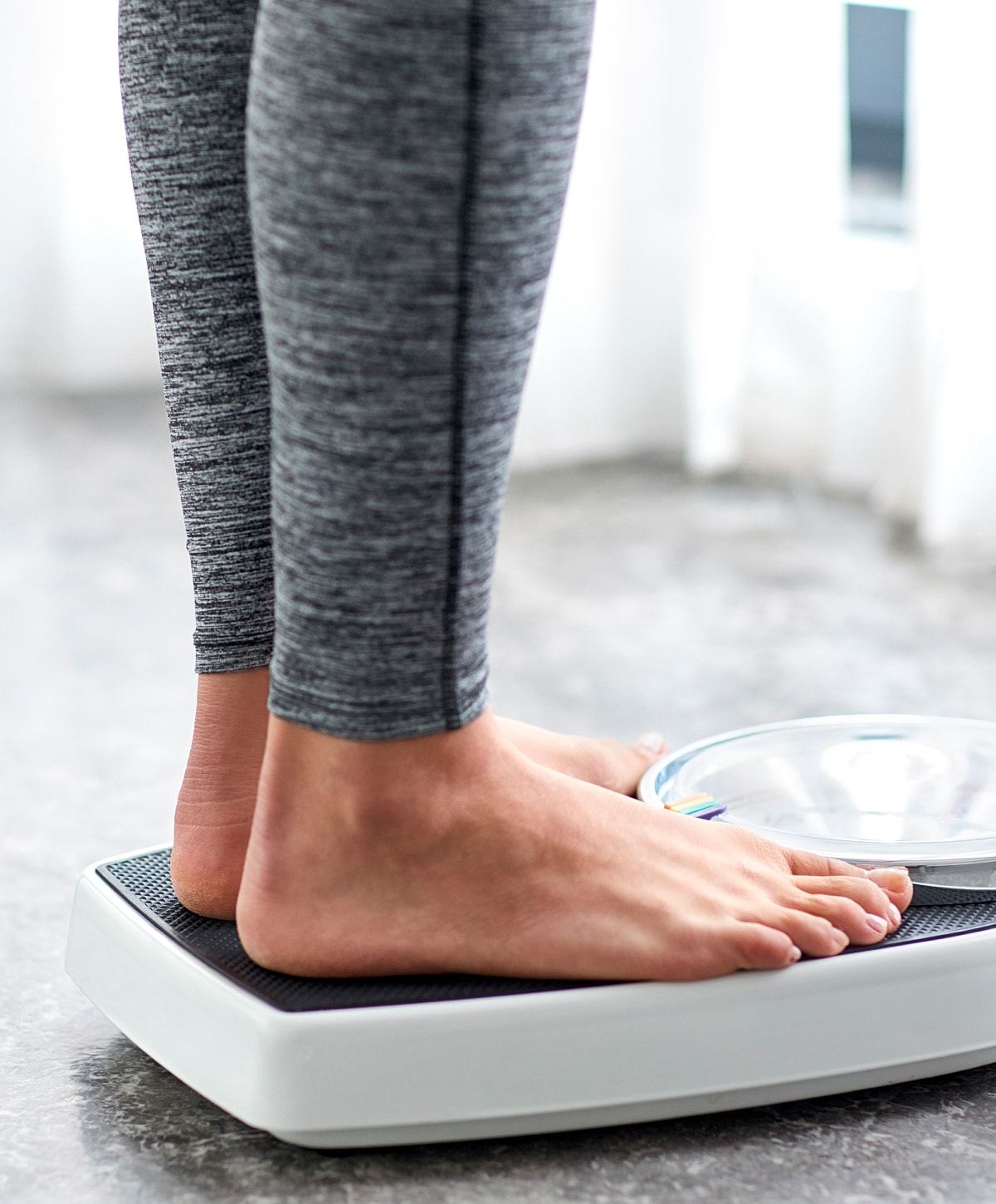 Person standing on a bathroom scale.