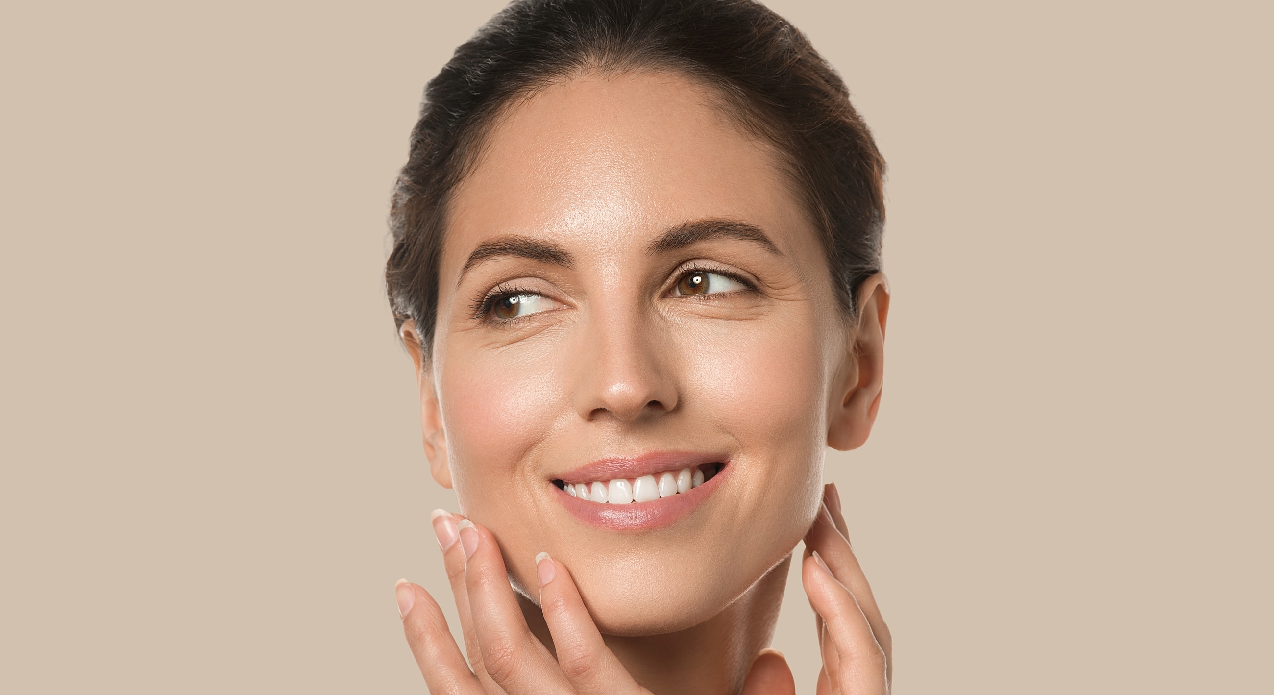 Smiling woman with healthy, glowing skin.