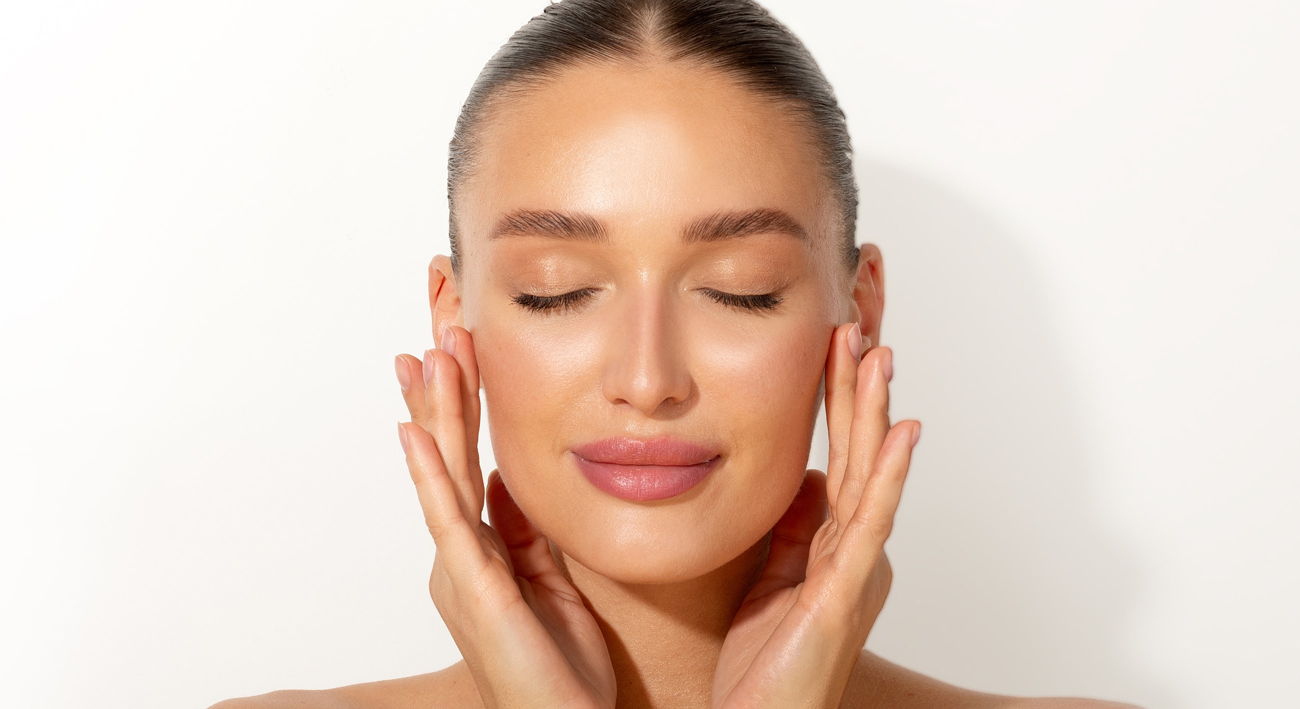 Woman with skincare, eyes closed, serene expression.