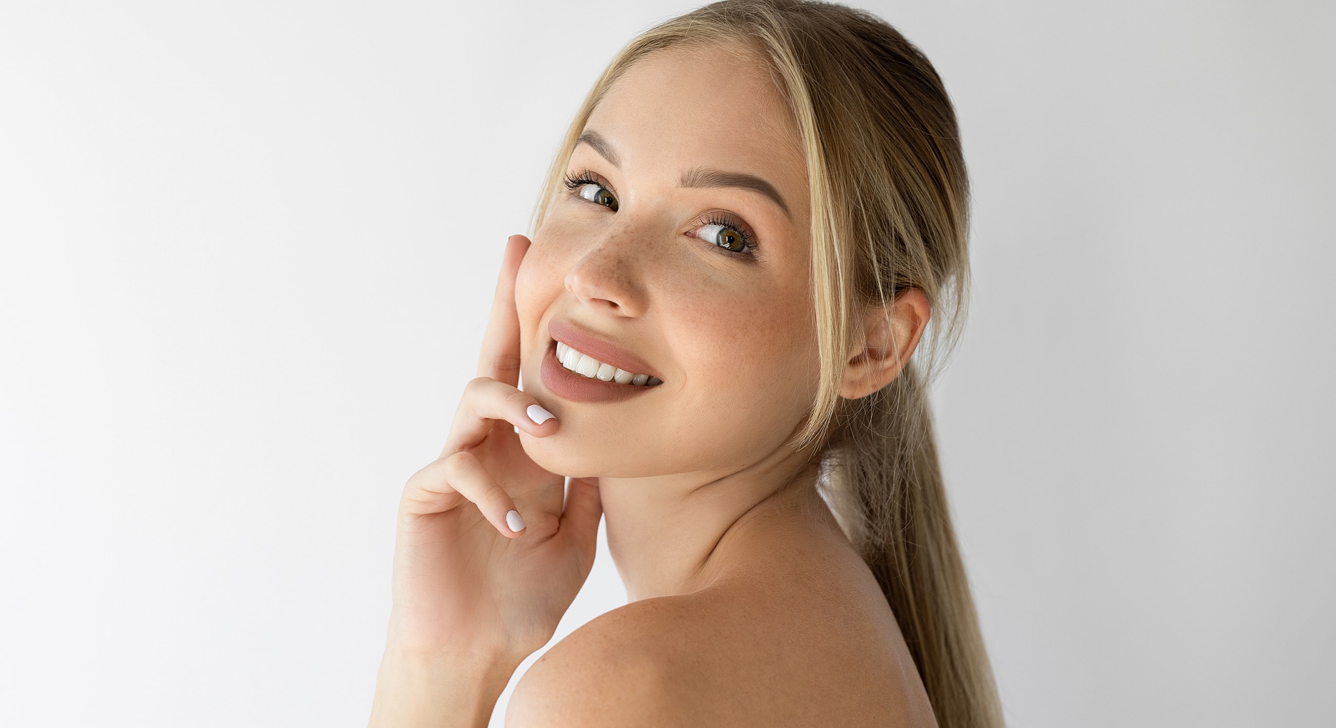 Smiling woman with light makeup and natural beauty.