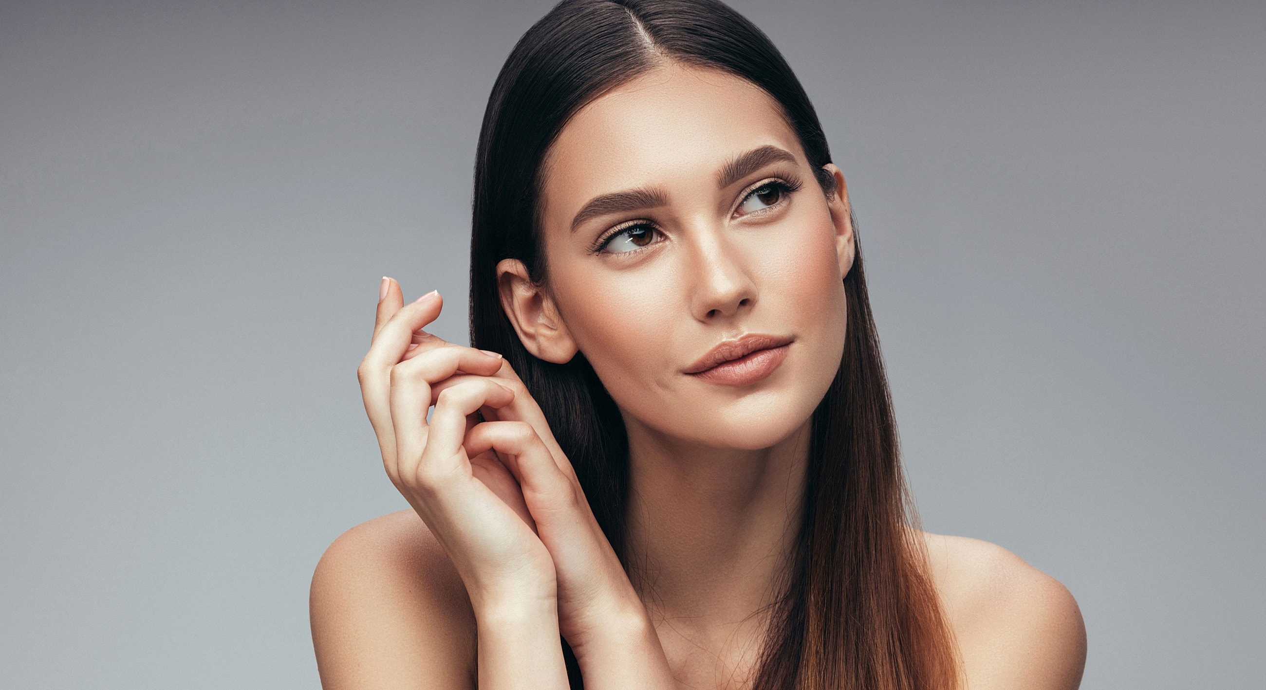 Woman with long hair and thoughtful expression.
