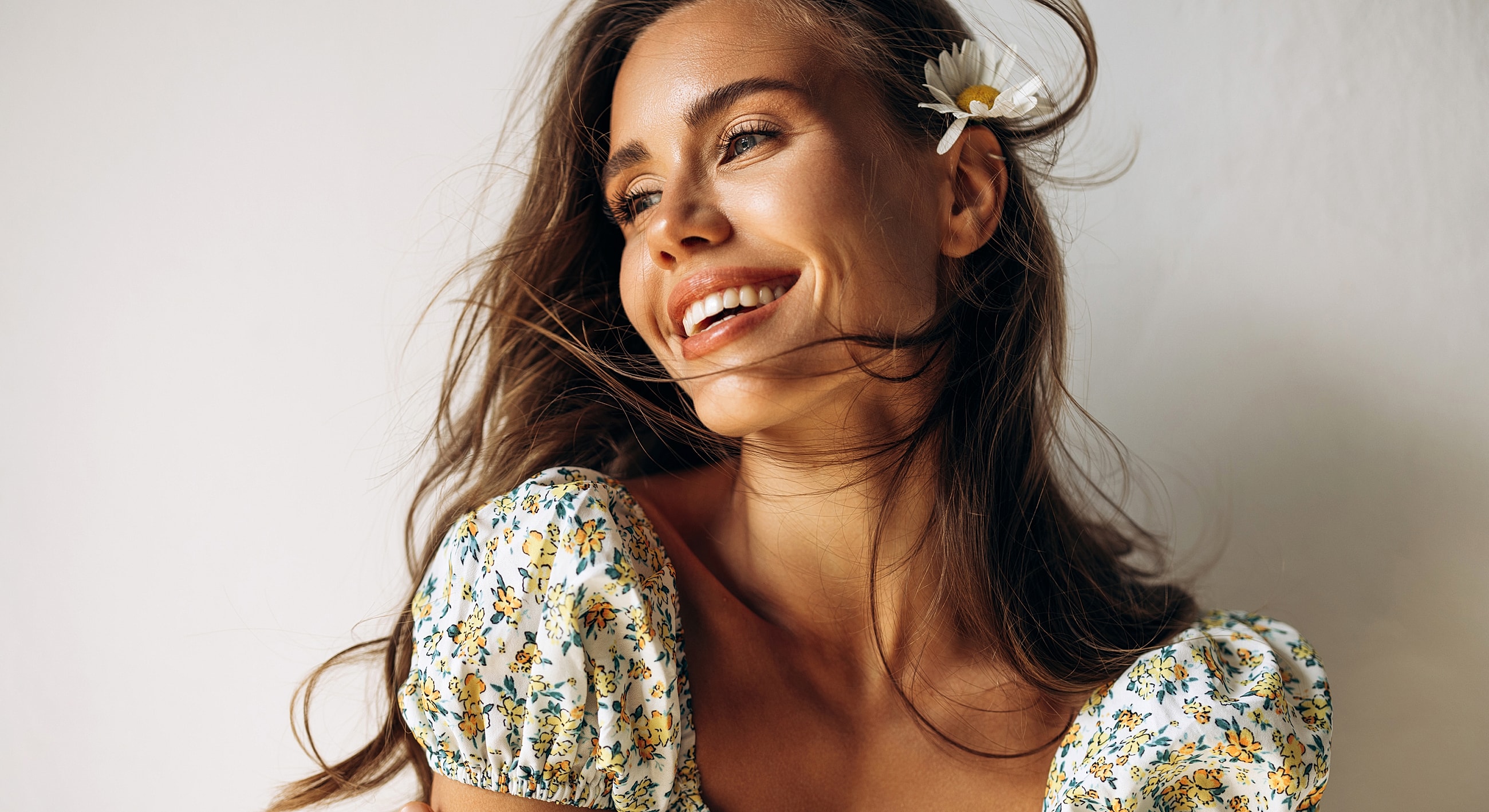 Smiling woman with flower in her hair.
